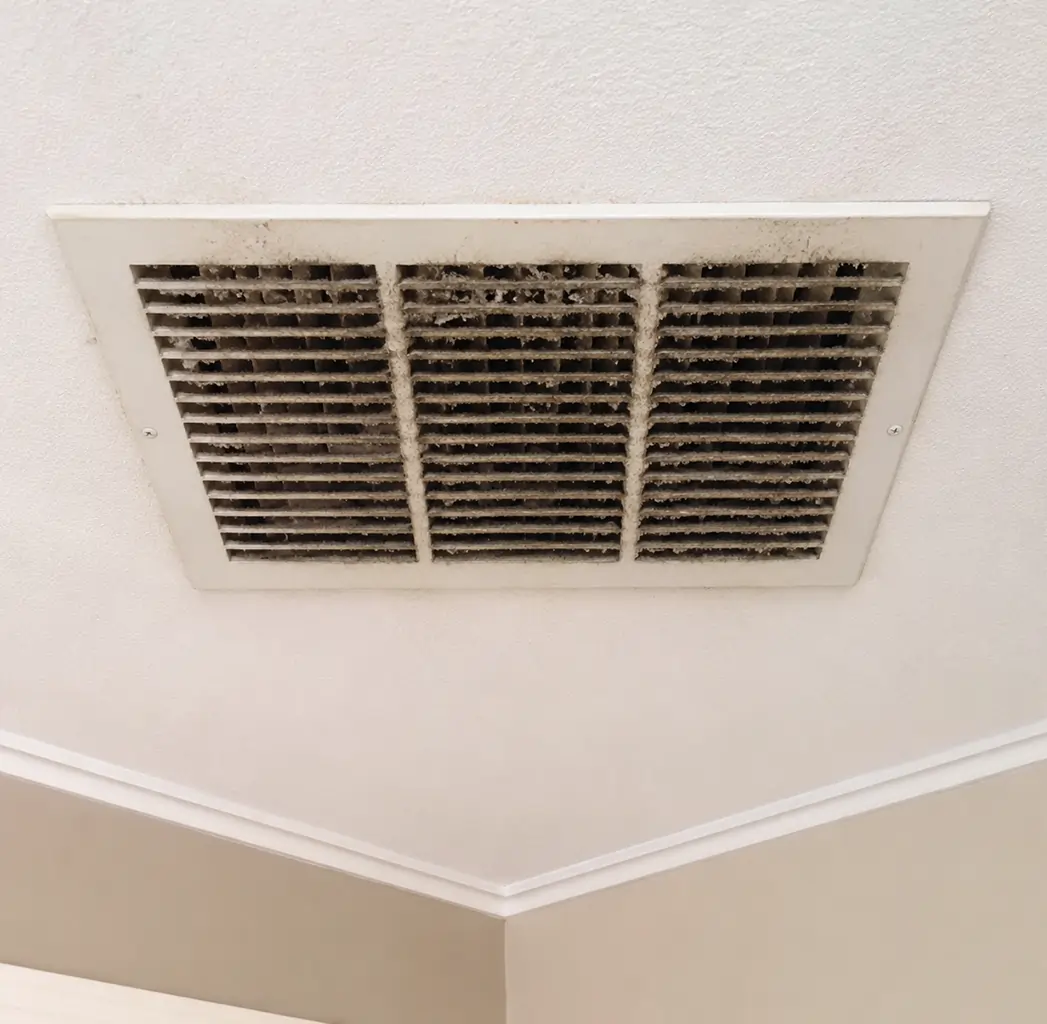 Dirty ceiling air vent with dust buildup